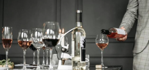 Image of a person pouring wine 
